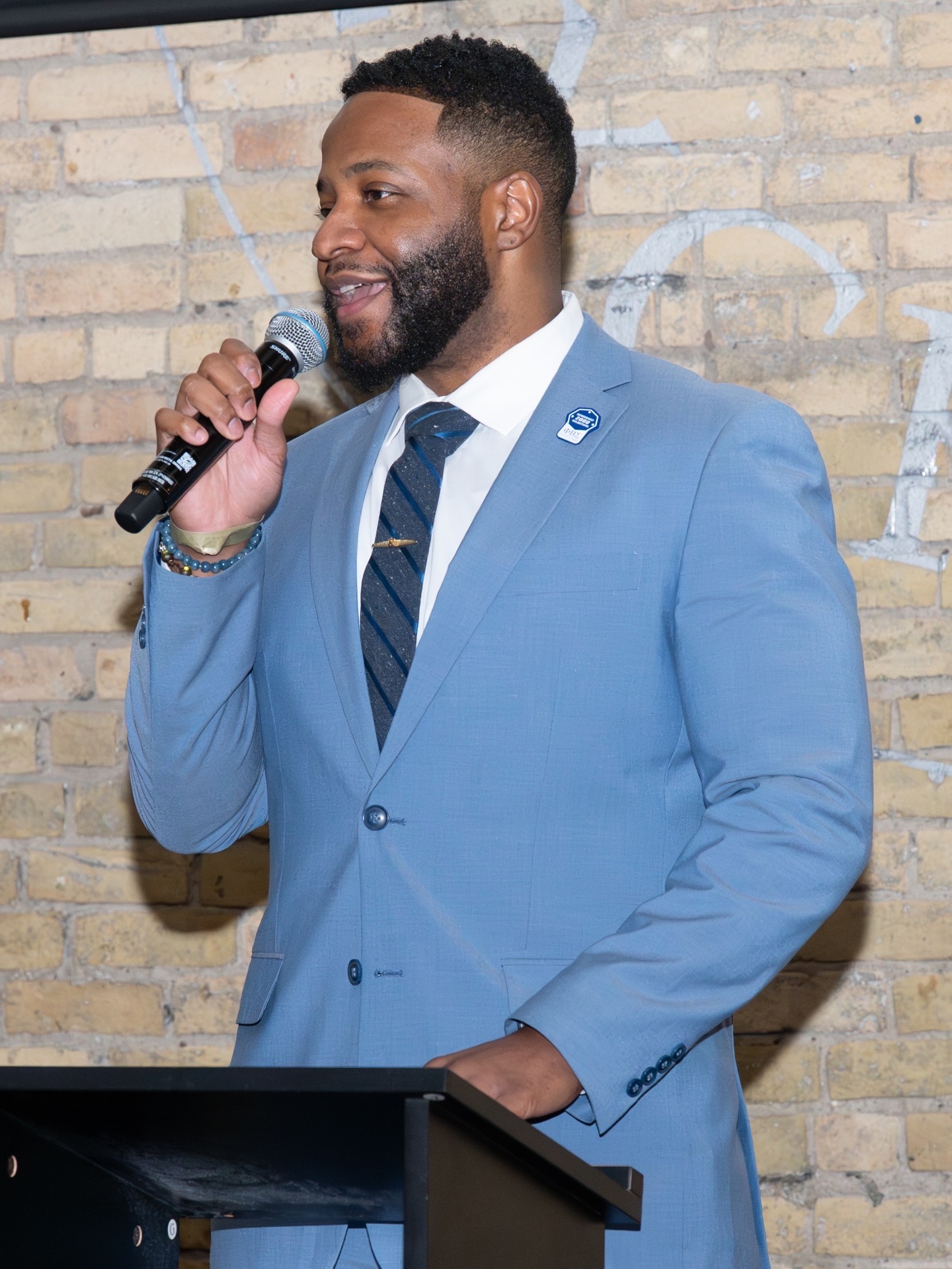 Robert Harper speaking at a podium